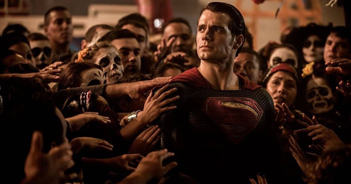 Henry Cavill as Superman, surrounded by civilians, in 