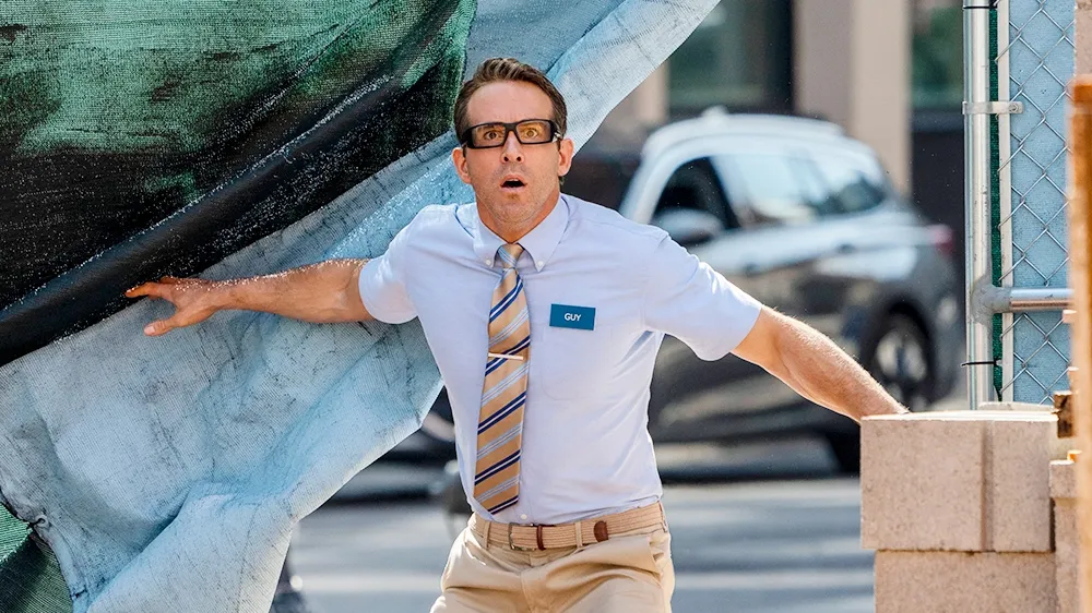 Ryan Reynolds dressed as a bank teller looking confused