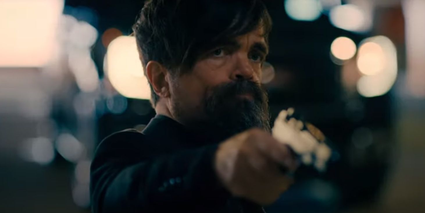 Peter Dinklage points a gun in I Care A Lot