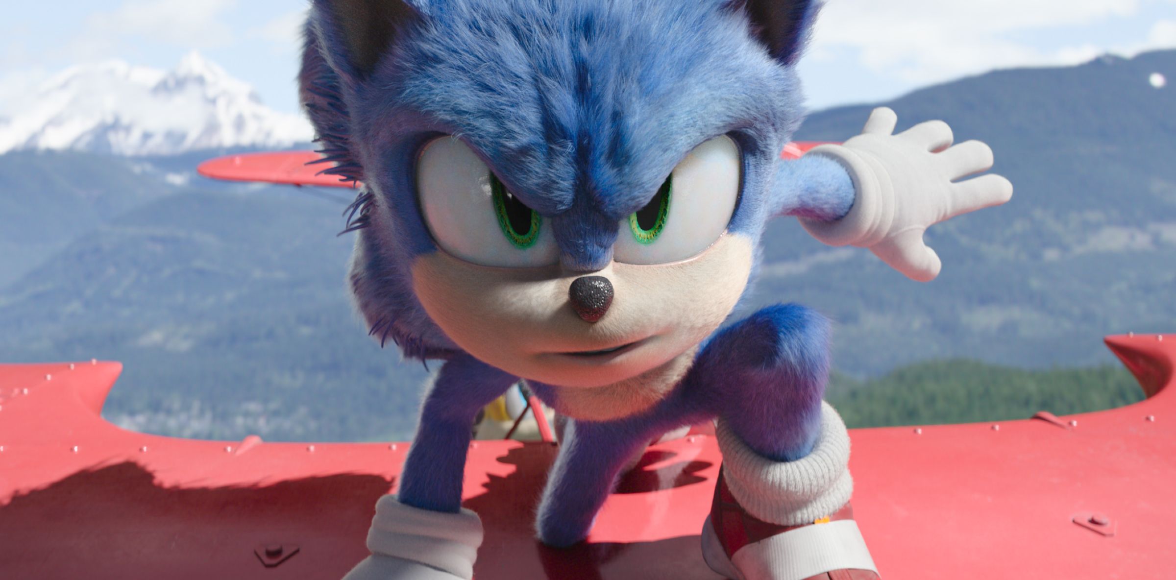 Sonic kneels on top of red plane wing