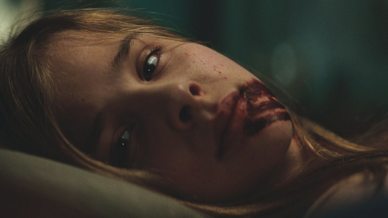 Chloe Grace Mortez with blood running from her mouth.