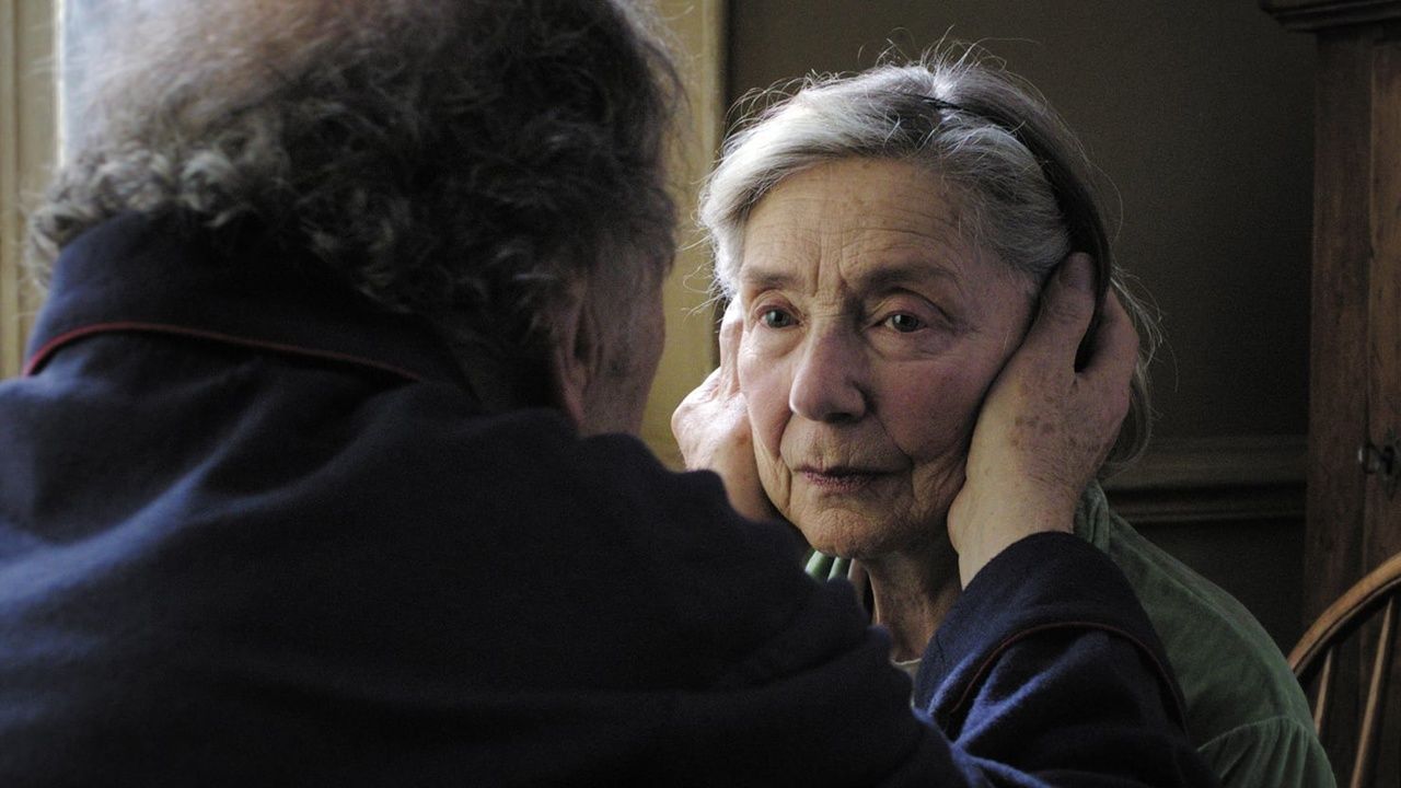 Jean-Louis Trintignant holds Emmanuelle Riva's face in Amour
