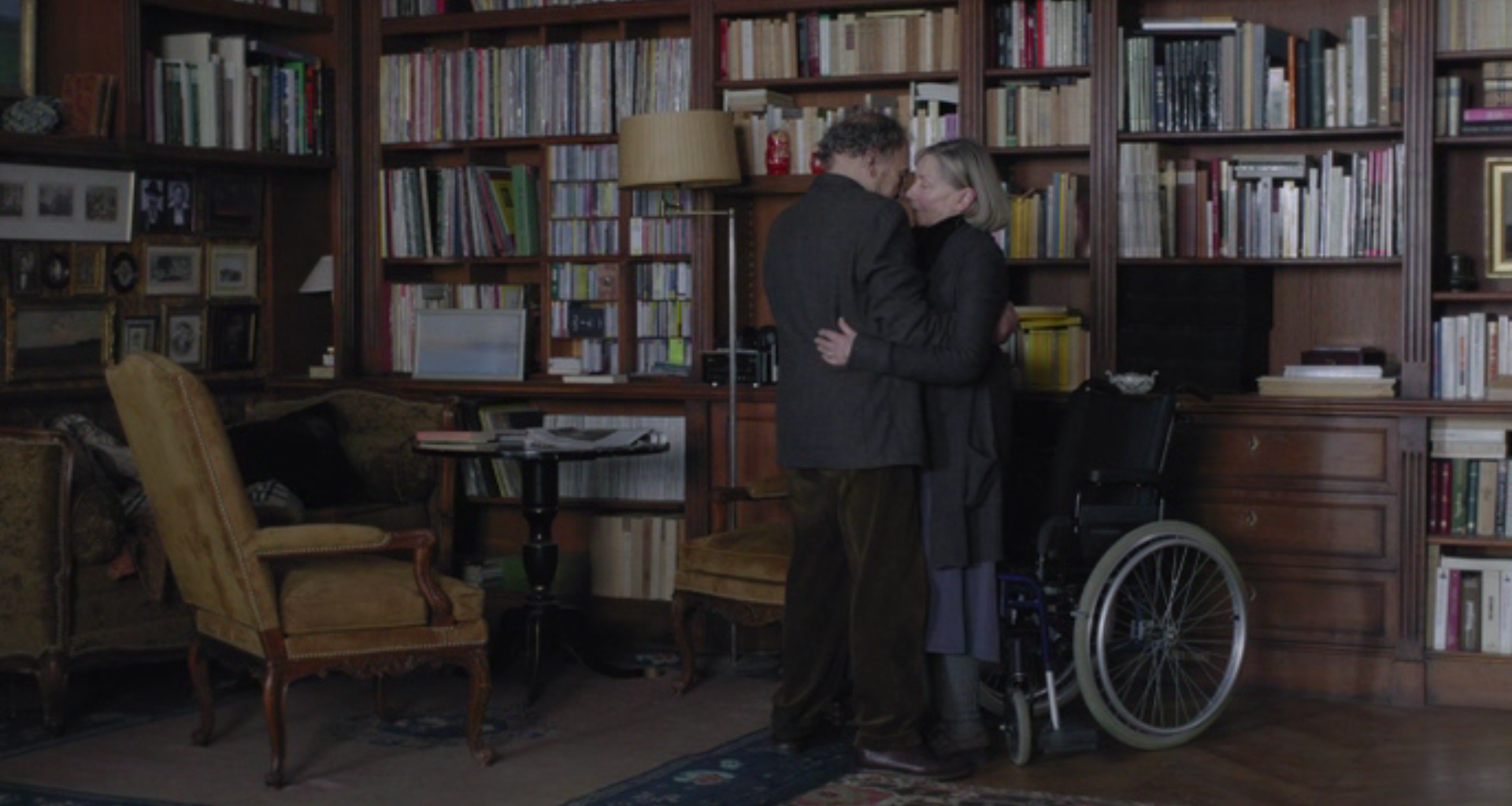 Elderly man and woman hug