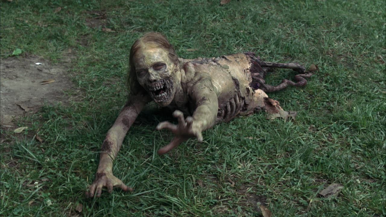 A zombie crawls on the ground in The Walking Dead 
