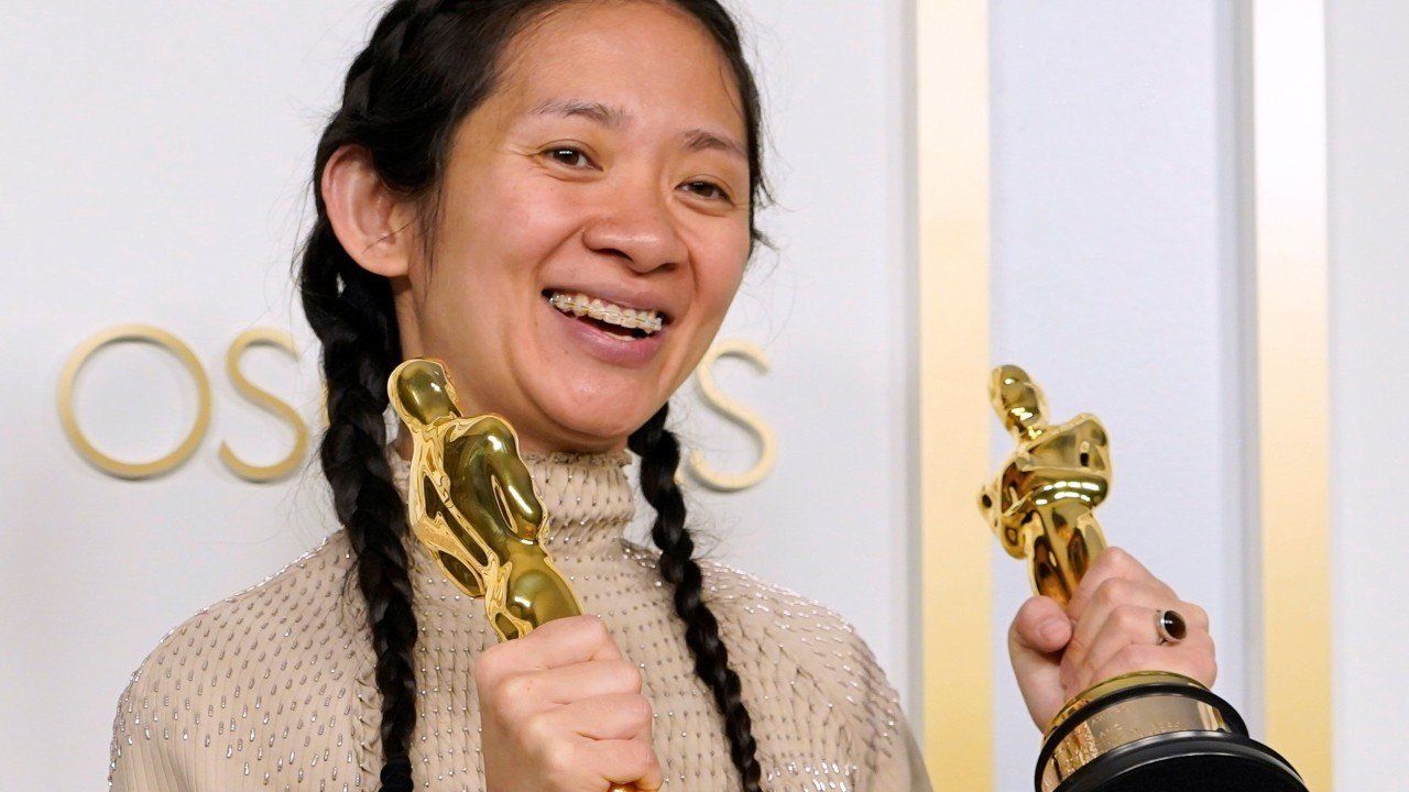 Chloe Zhao holds her two Oscars from the 2021 Academy Awards