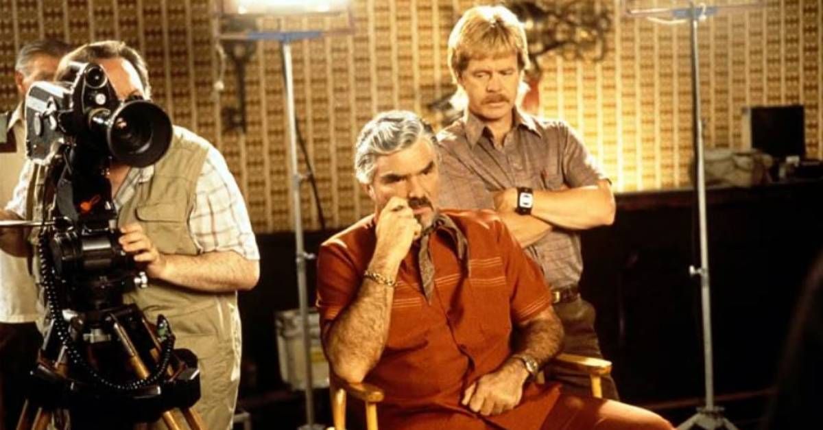 Ricky Jay, Burt Reynolds and William H. Macy shoot a film in character during a scene from "Boogie Nights" (1997).