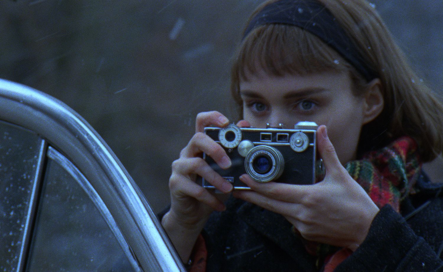 Rooney Mara takes a picture in Carol. 
