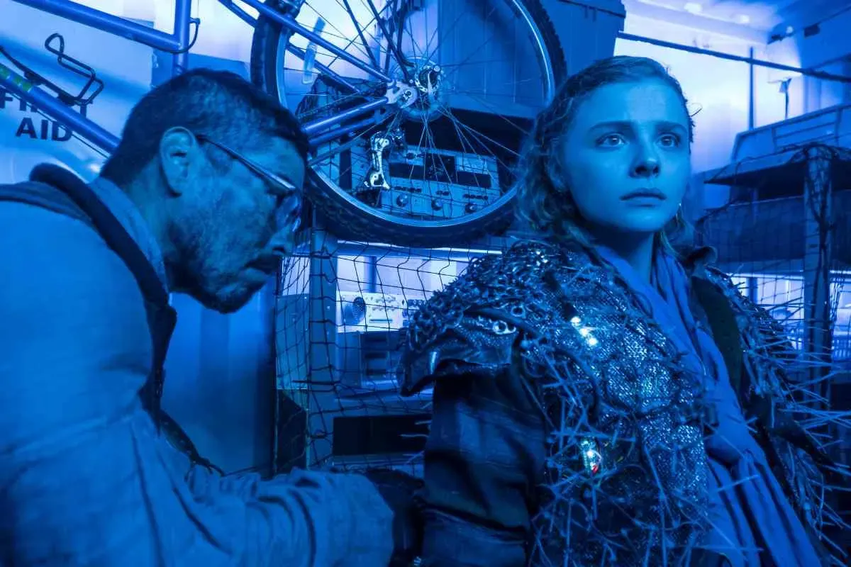 Chloe Grace Moretz has her invisibility suit fitted on by Arthur in Mother/Android