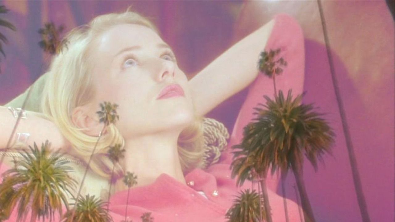 Naomi Watts reclines, superimposed on Californian skylines
