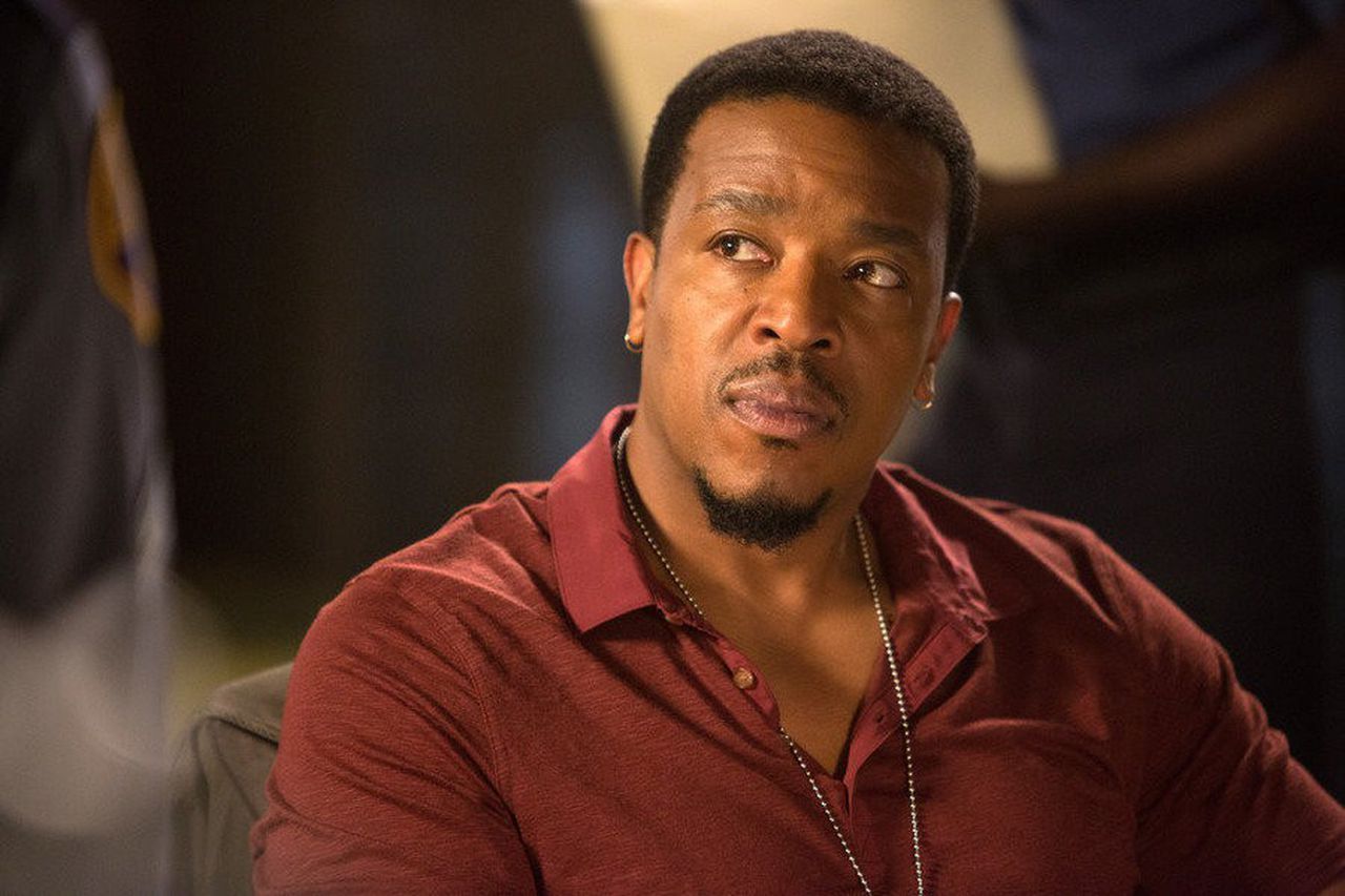 Russell Hornsby glancing upward in The Hate U Give