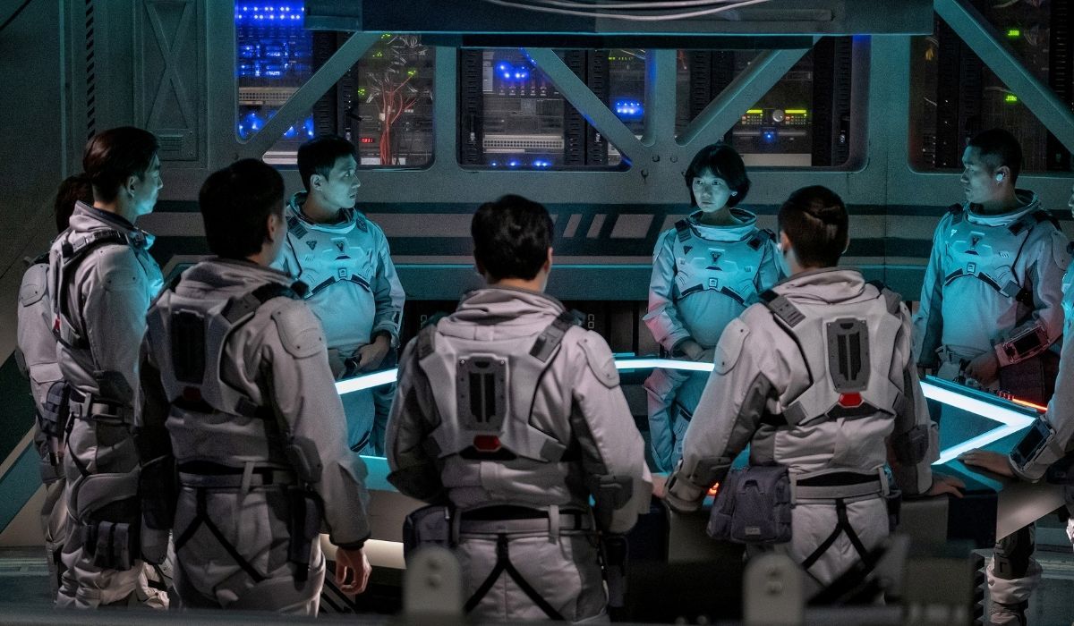 The cast sits around a high-tech table in the Silent Sea