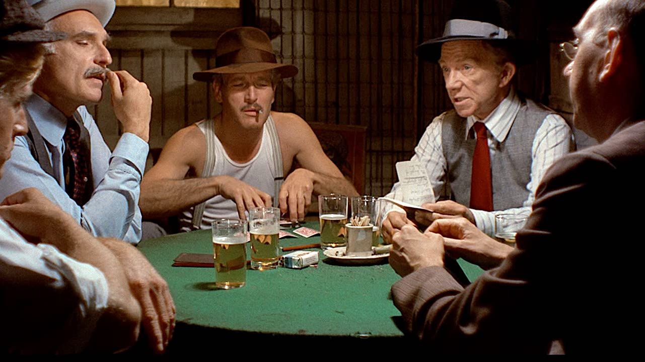 Paul Newman plays cards at the poker table in The Sting