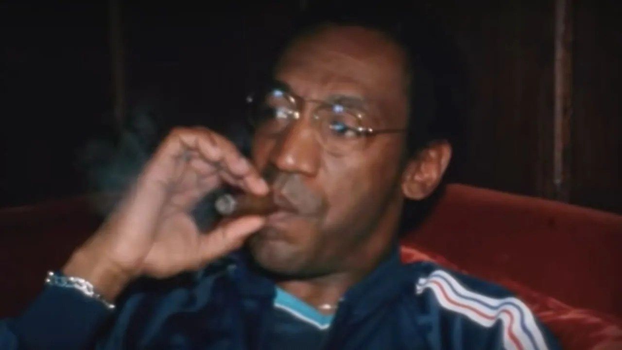 Younger Bill Cosby smoking a cigar in We Need To Talk About Cosby 
