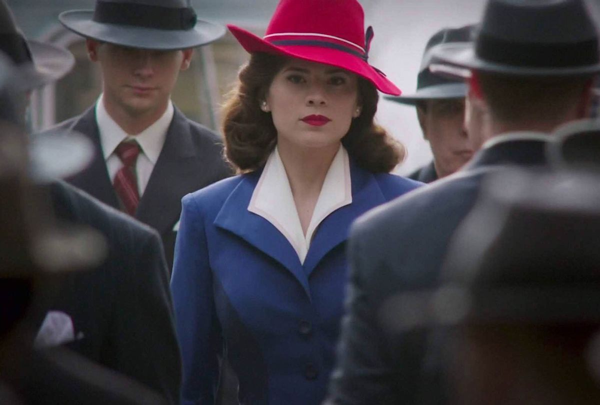 Hayley Atwell as Agent Carter standing out in bright clothes against a dull crowd.