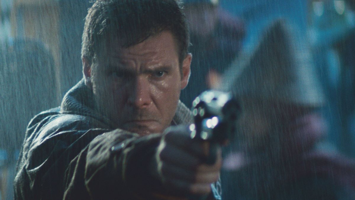 The blade runner Rick Deckard in the rain pointing a gun just offscreen.
