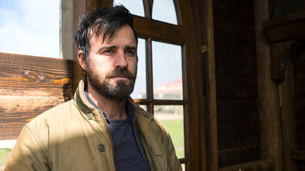 Justin Theroux standing by a window in the Leftovers. 