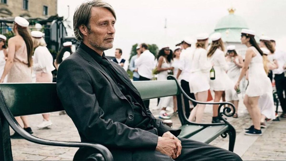 Mads-Mikkelsen-In-Another-Round-Sitting-On-A-Bench