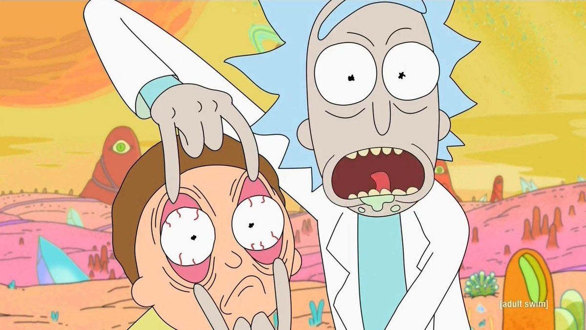 An image of Rick shouting and painfully forcing Morty's eyes open on an alien planet.
