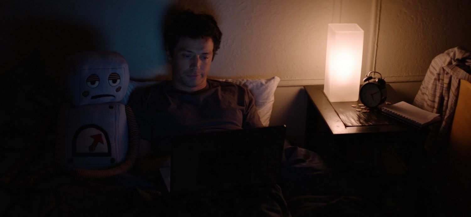 Christian Coulson next to his robot pillow in Bite Me