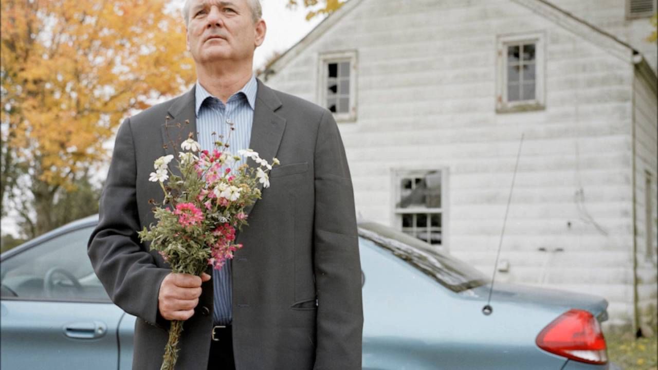 Bill Murray holds some flowers and looks like a chump