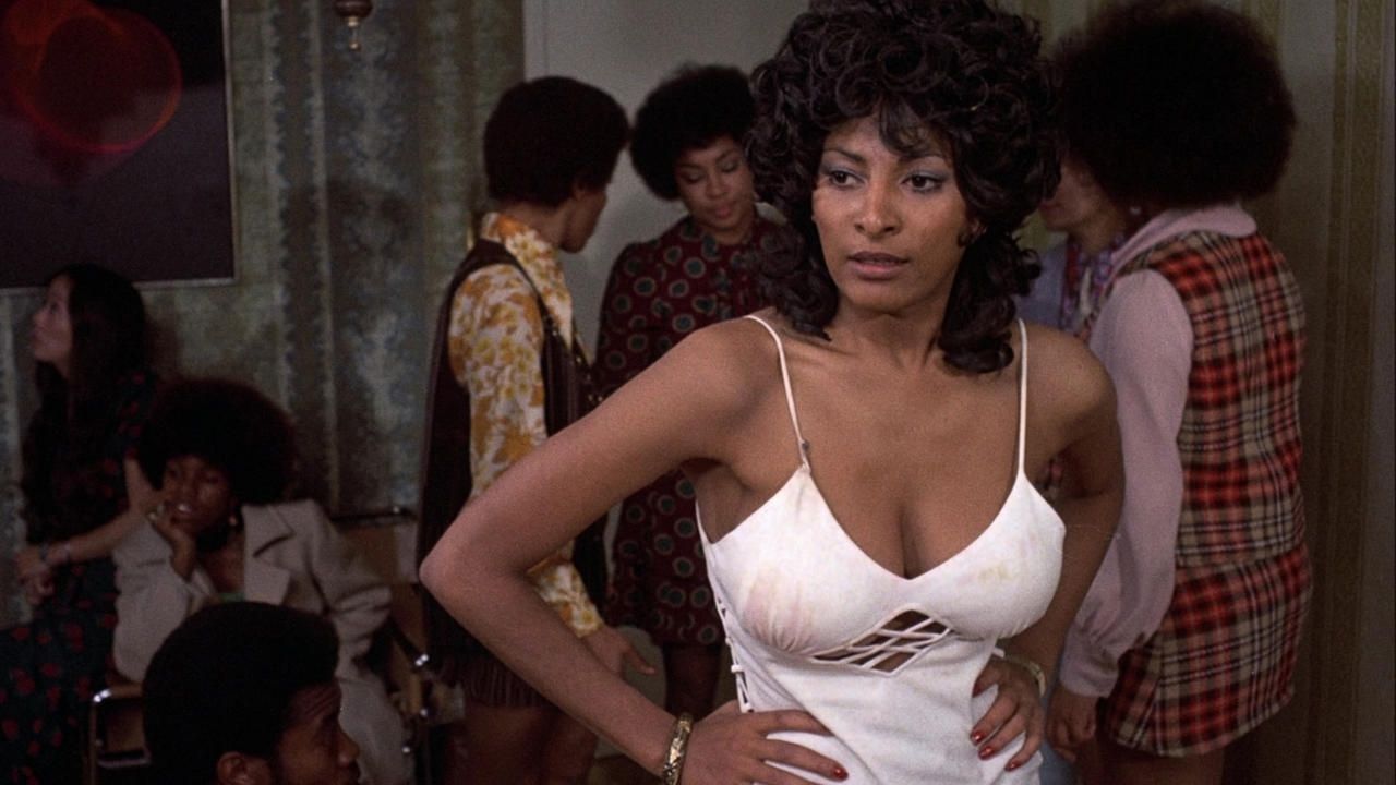 Nurse Flower Child "Coffy" Coffin (Pam Grier) disguises as a prostitute to lure King George to seek revenge