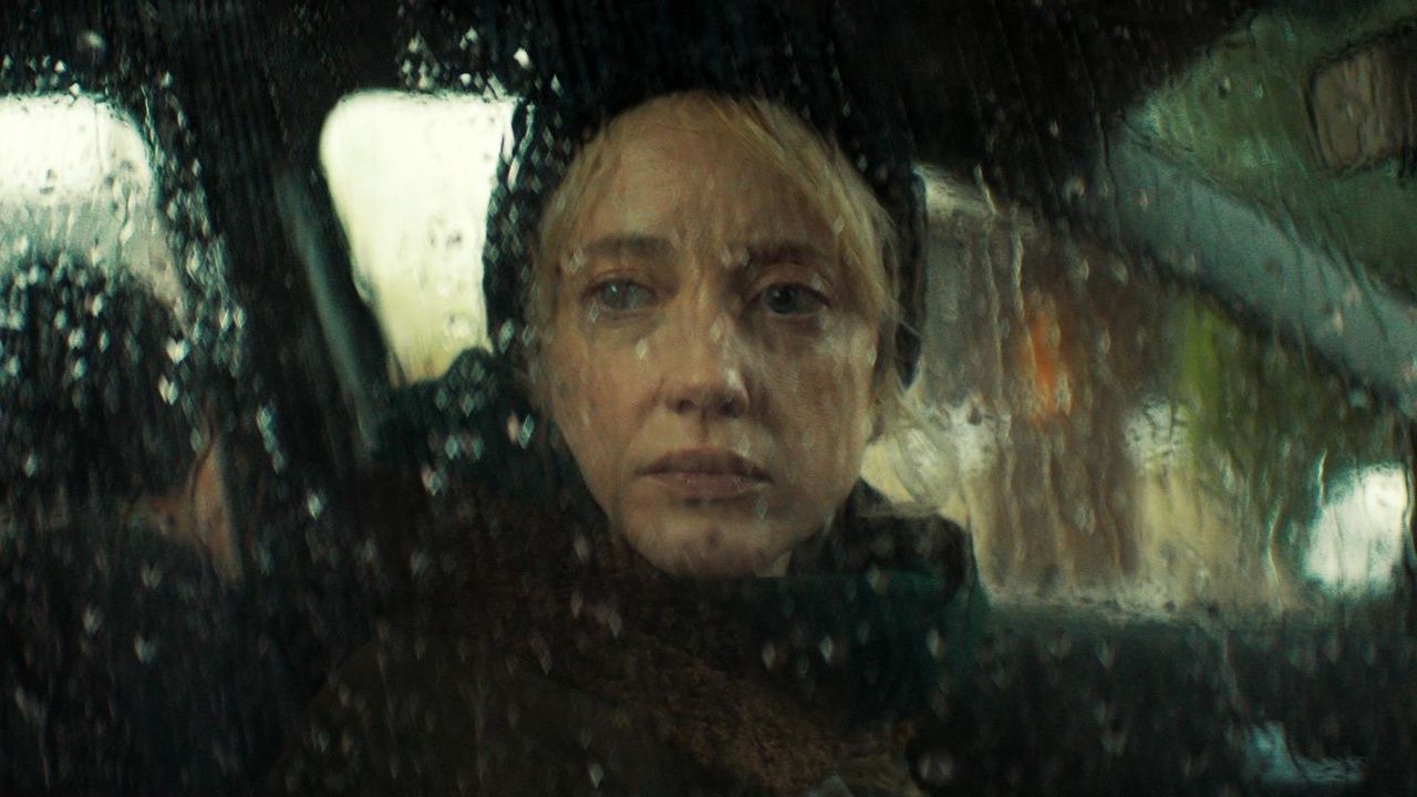 Andrea Riseborough in a car in the rain