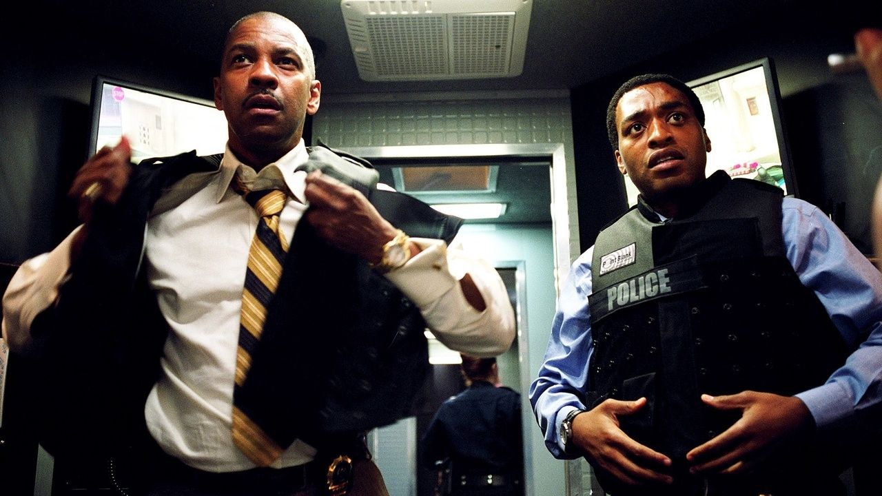 Denzel Washington changes uniforms in a vault in Inside Man