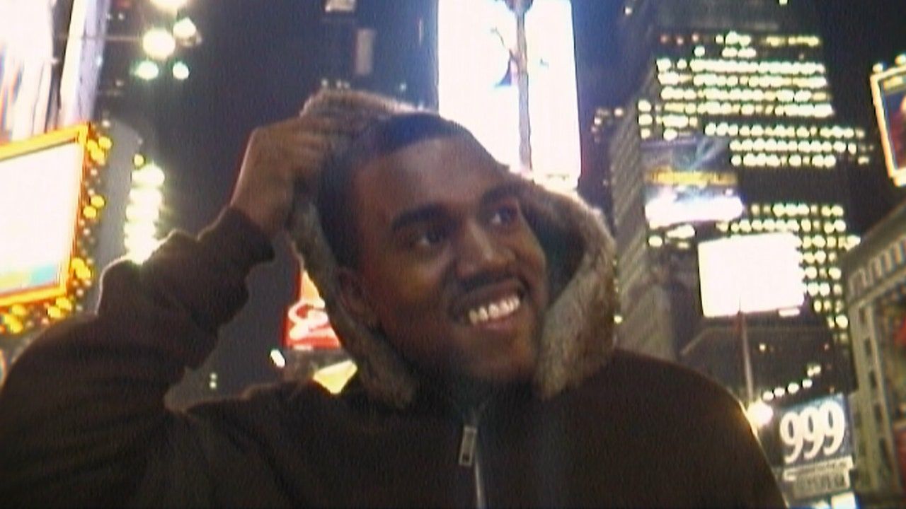 Kanye West takes off his hoodie in New York