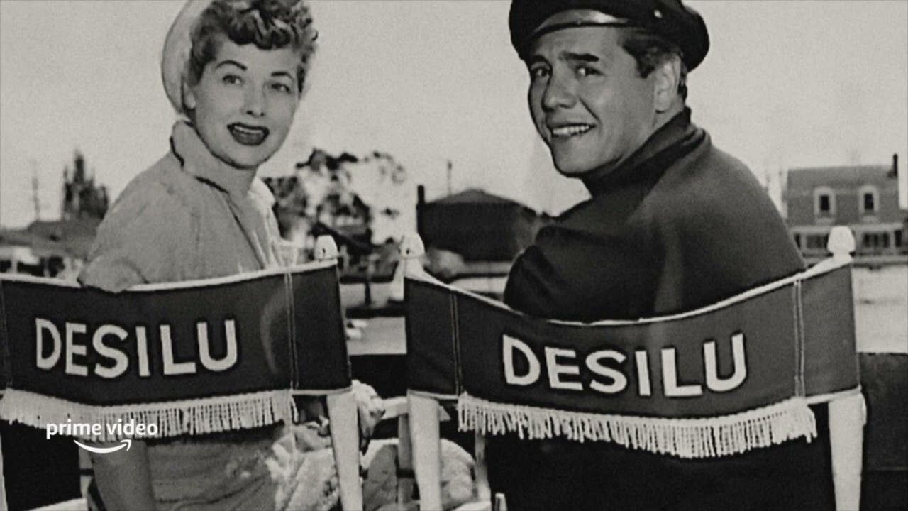 Lucy and Desi sit in their Desilu producers chairs on set