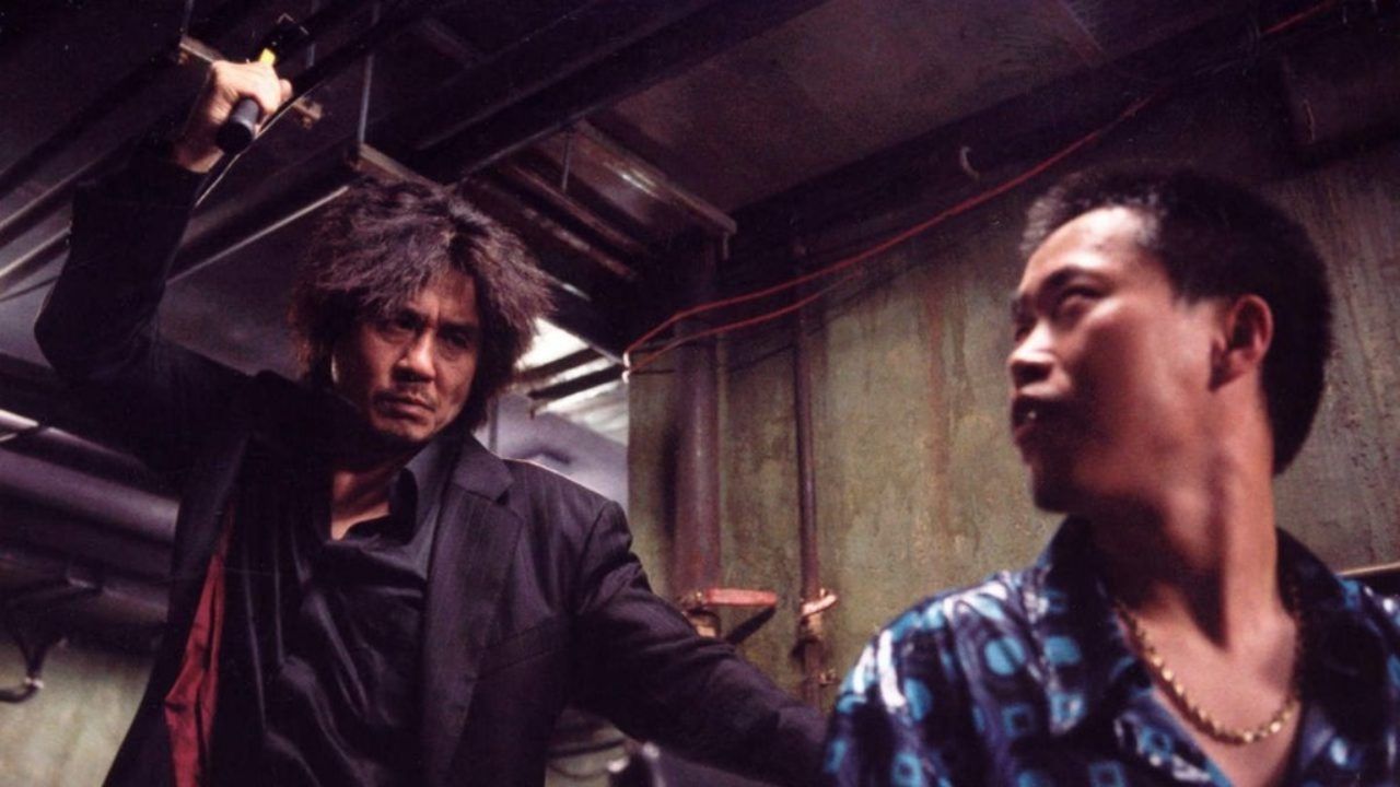 Oldboy, the main character holds a hammer over a seated man's head