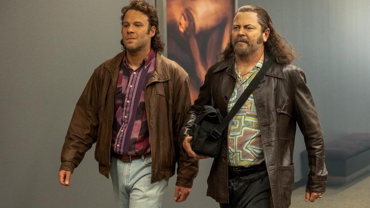 Rogen and Offerman confidently walk down a hallway