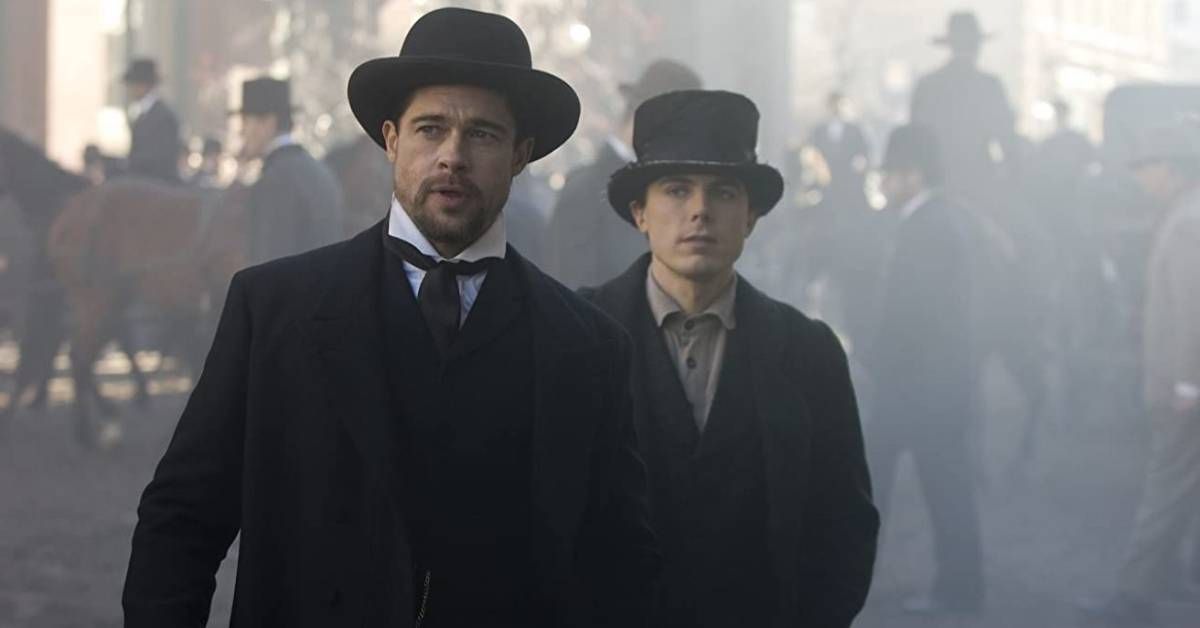 Brad Pitt and Casey Affleck, in character, stand together during a tense outdoor scene from The Assassination of Jesse James by the Coward Robert Ford (2007).