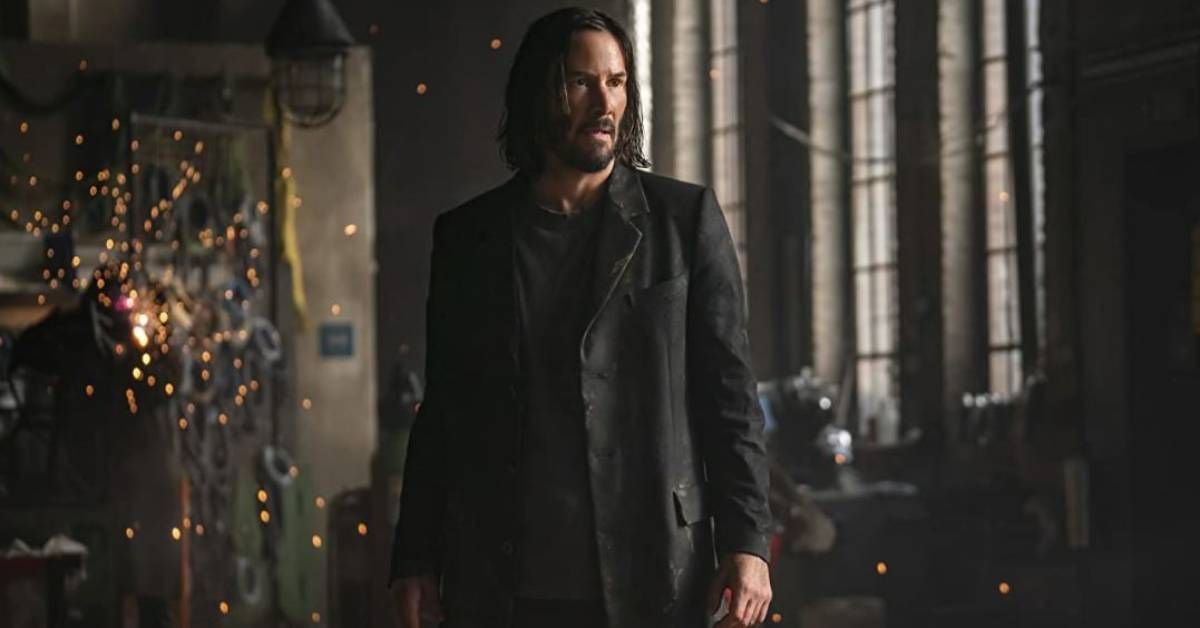 Keanu Reeves, in character as Neo, stands during an indoor action scene from "The Matrix Resurrections" (2021).