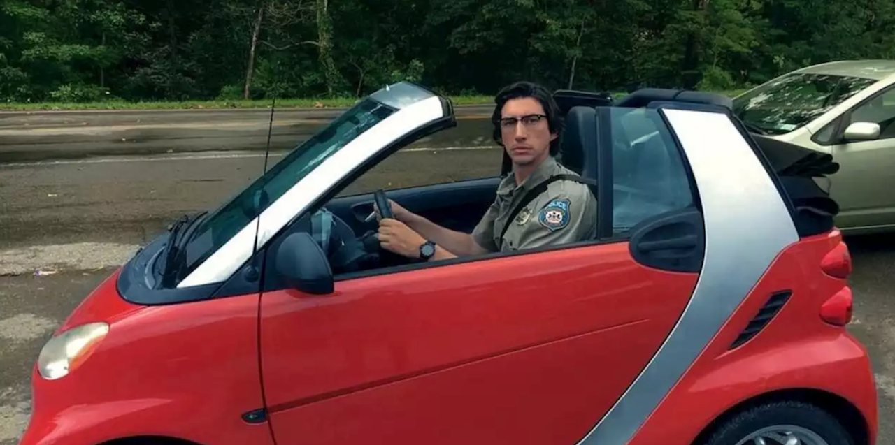 Adam Driver as a big cop in a small smart car in The Dead Don't Die