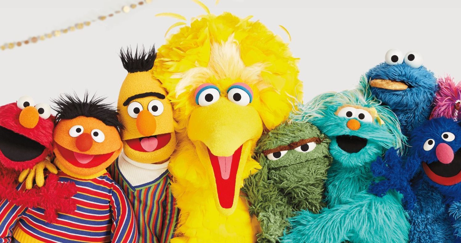 The puppet cast of Sesame Street, brightly lit and facing camera