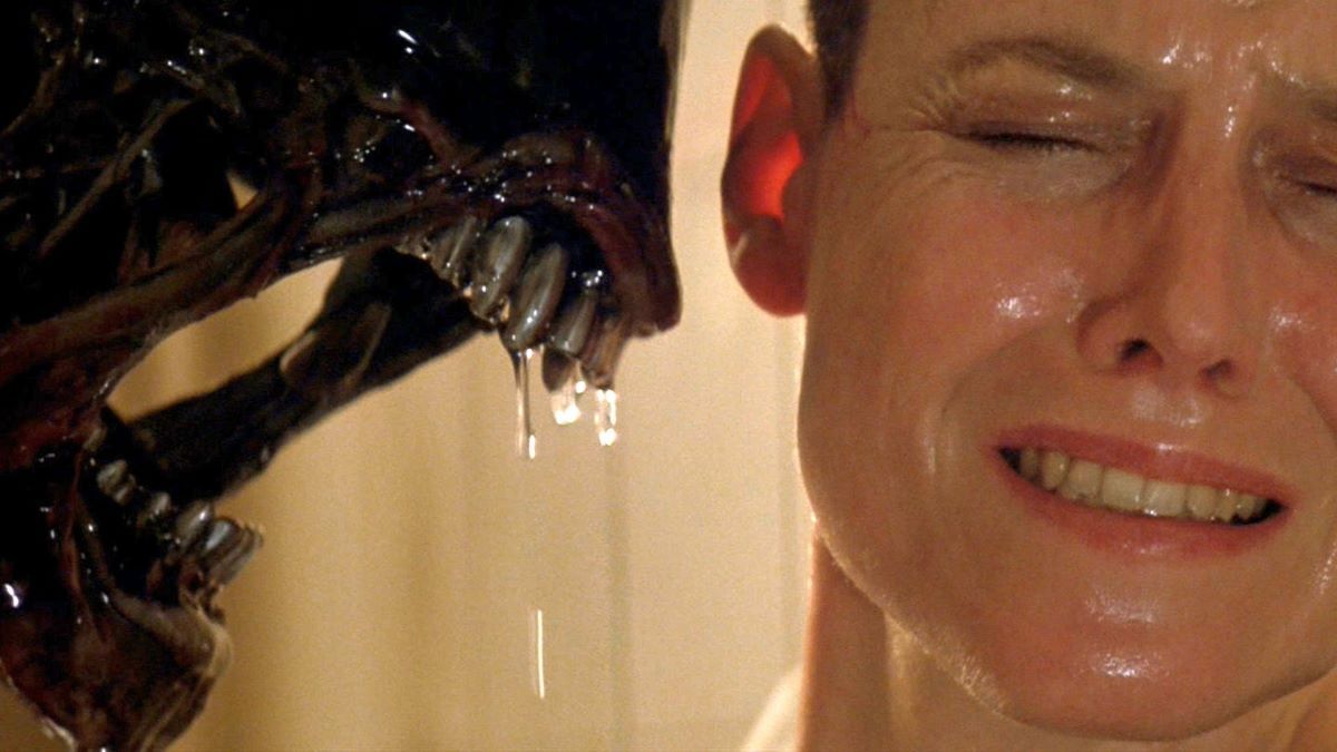 The xenomorph leaning in close to a disgusted Ripley