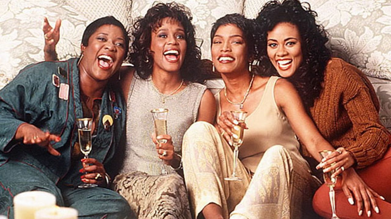 Four women sit around with champagne glasses.