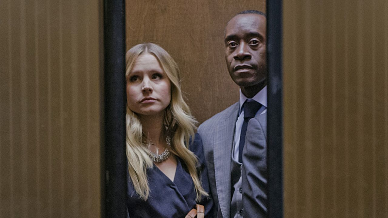 Kristen Bell and Don Cheadle in and elevator that is closing.