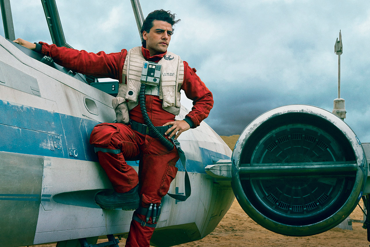 Oscar Isaac standing near fighter plane in The Force Awakens. 