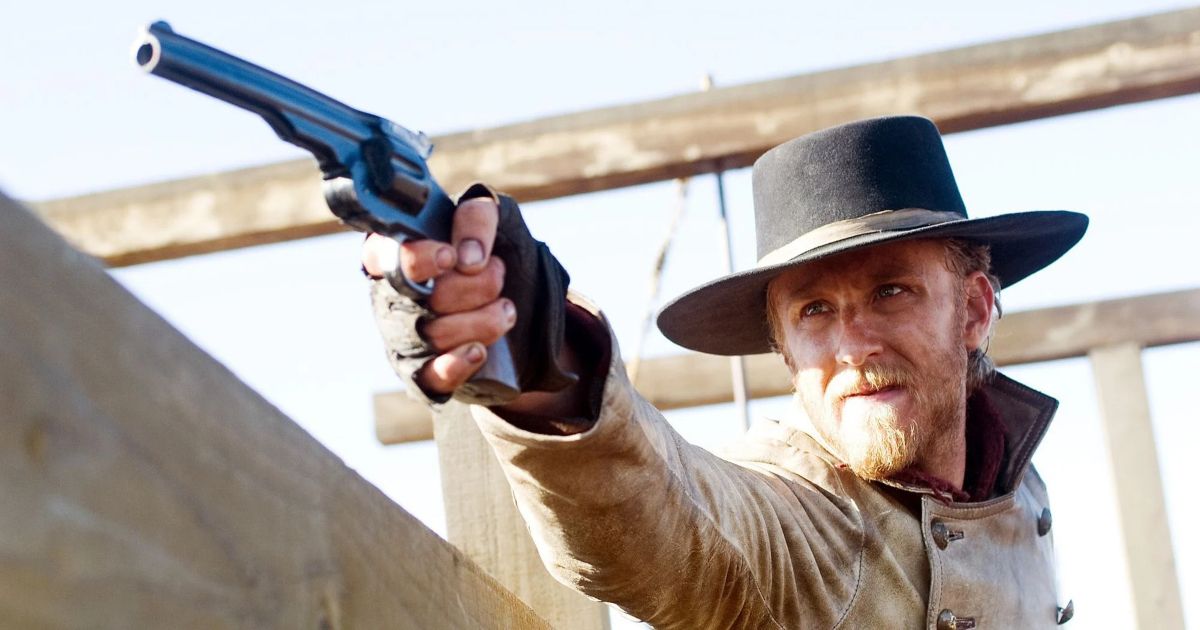 Foster as Charlie Prince holds a gun at the camera in 3:10 to Yuma