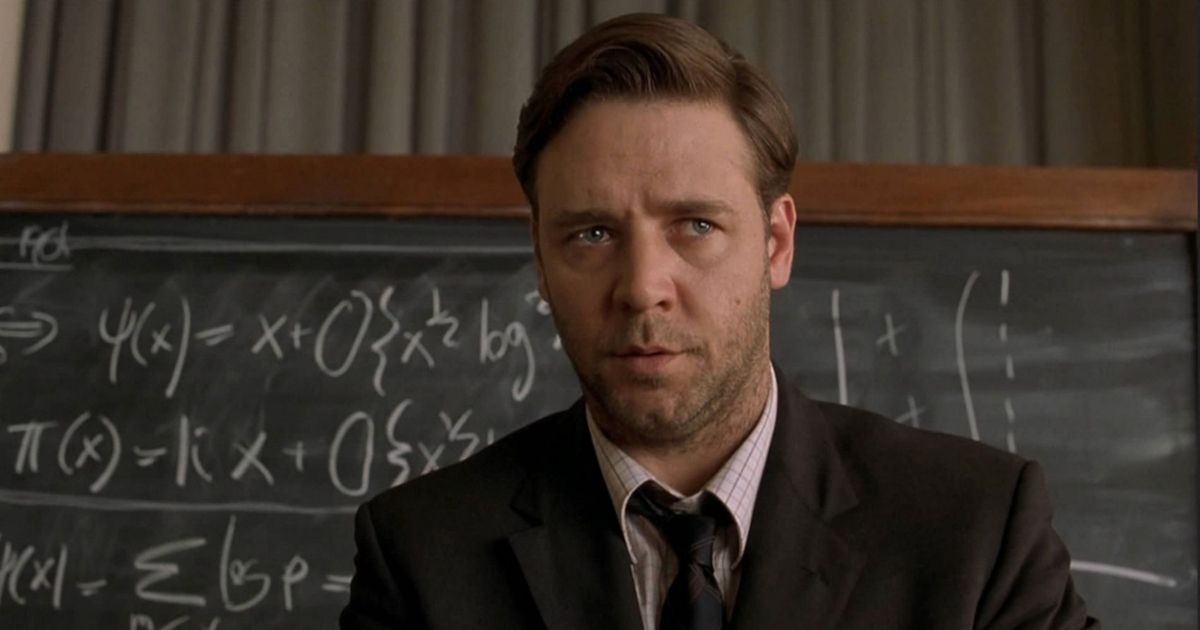 Russel Crowe stands in front of an equations filled chalkboard in A Beautiful Mind