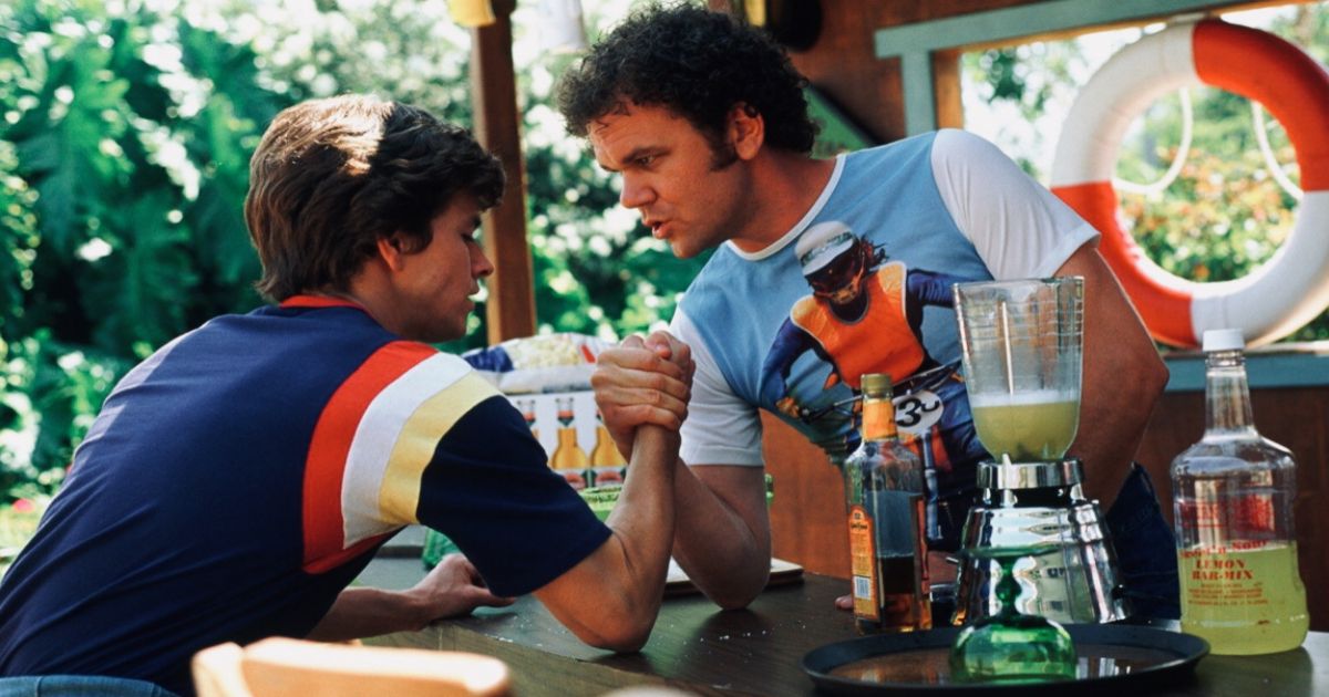 Reilly and Wahlberg arm wrestle in Boogie Nights