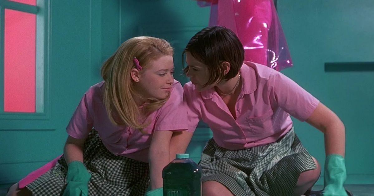The two characters in pink kiss in a bathroom