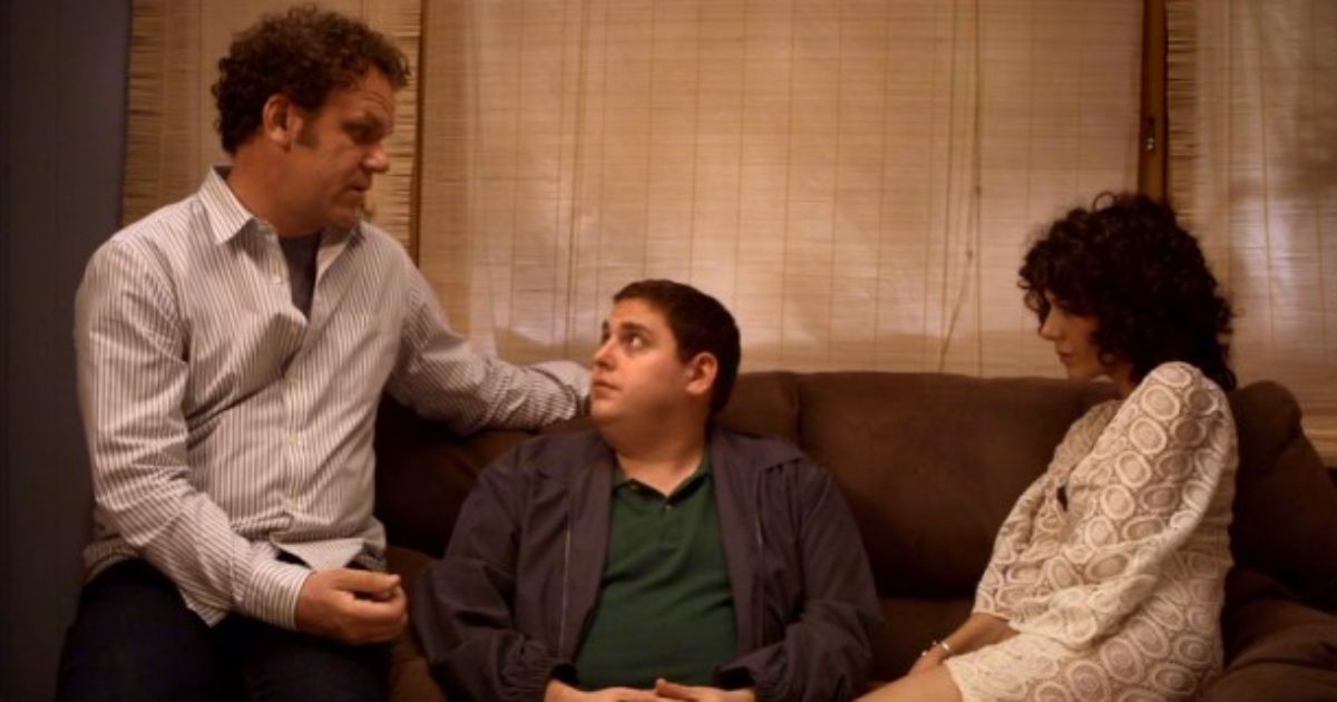 Jonah Hill flanked by Reilly and Tomei on the couch in Cyrus