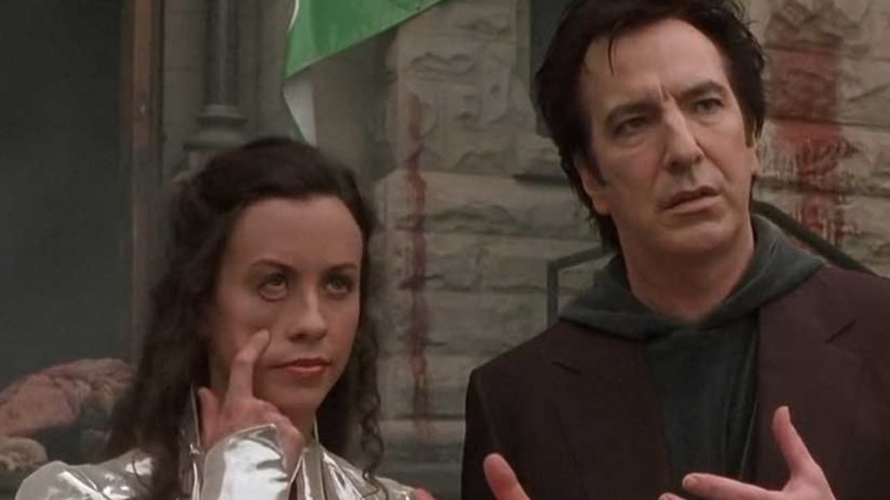 Alanis Morrisette pulls her eye down, playing God and standing outside a church with Alan Rickman