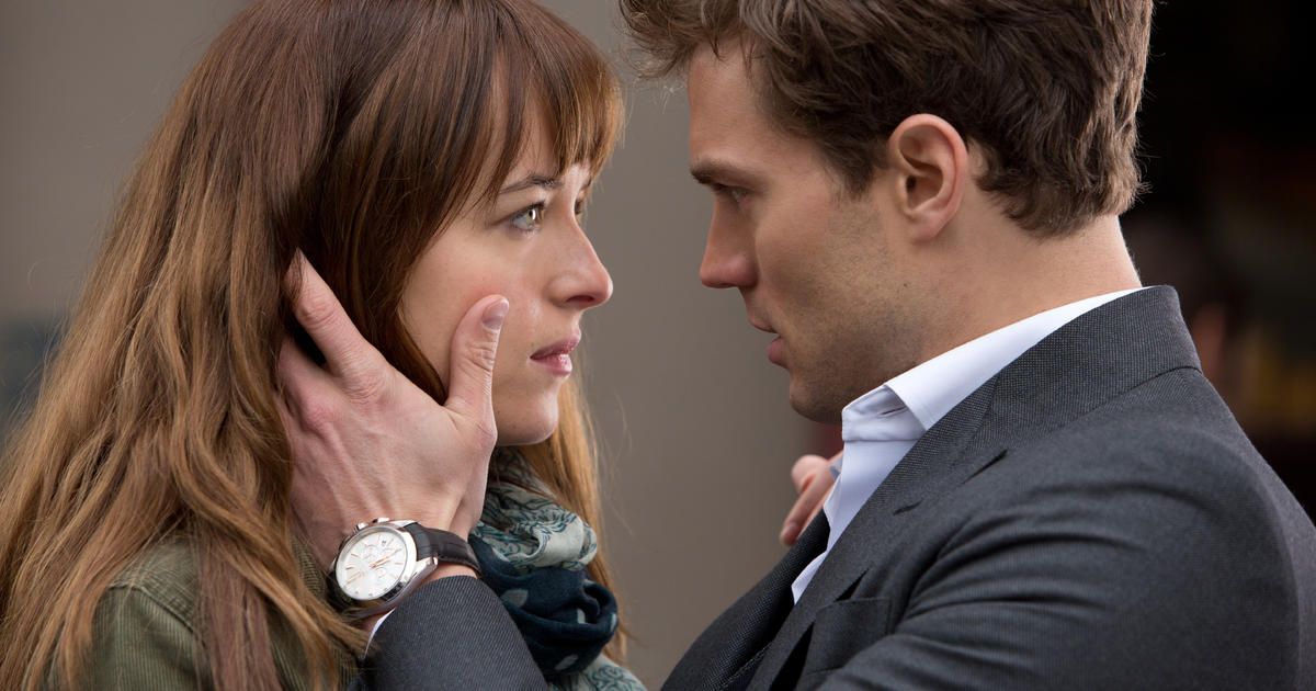 Christian holding Anastasia's face as always in Fifty Shades of Gray