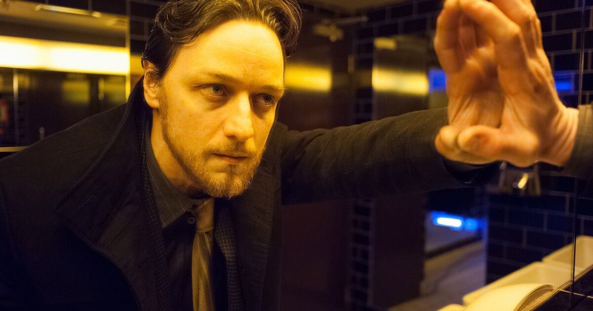 James McAvoy stares into the mirror and puts his hand against it in Filth