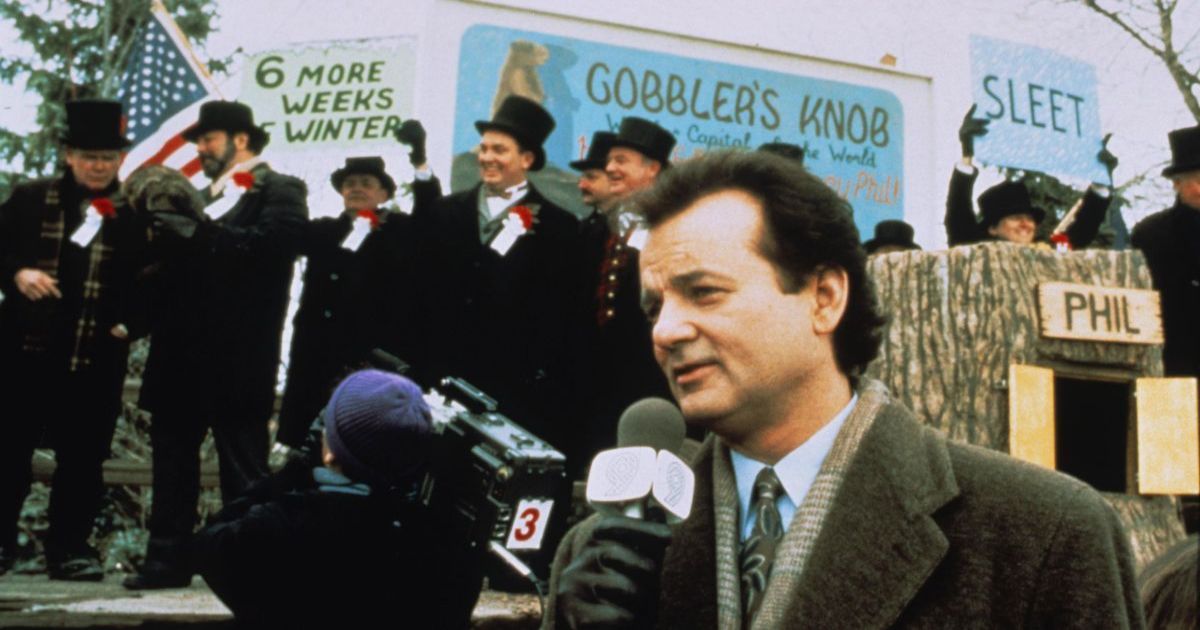 Bill Murray does the weather report surrounded by signs