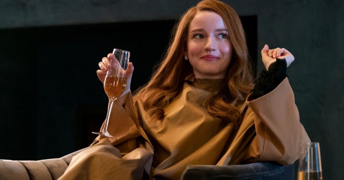 Delvey (Julia Harney) reclines with a champagne glass in Inventing Anna