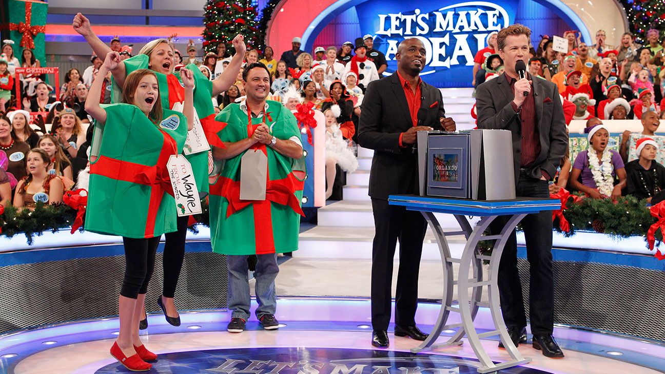 Contestants and the audience cheer in the bright set of Let's Make a Deal